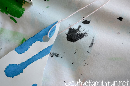 Use liquid watercolors and drip painting to make a beautiful mobile. This raindrop kids craft is a fun spring art project and perfect for a rainy day.