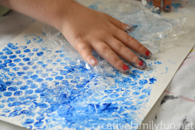 Create an underwater scene inspired by The Bahamas with this layered paper art project for kids combining printmaking with wet-on-wet watercolor.