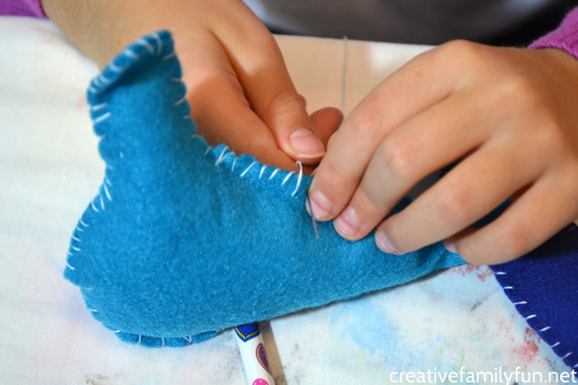 Make this simple felt bird ornament inspired by the book The Birds of Bethlehem by Tomie dePaola. It's a simple sewing project for kids.
