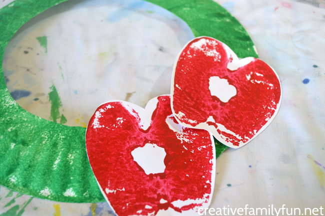 This fun Apple Print Wreath is a fun apple craft for kids to make this fall. It's a great craft for preschool and older kids and a fun fall decoration.