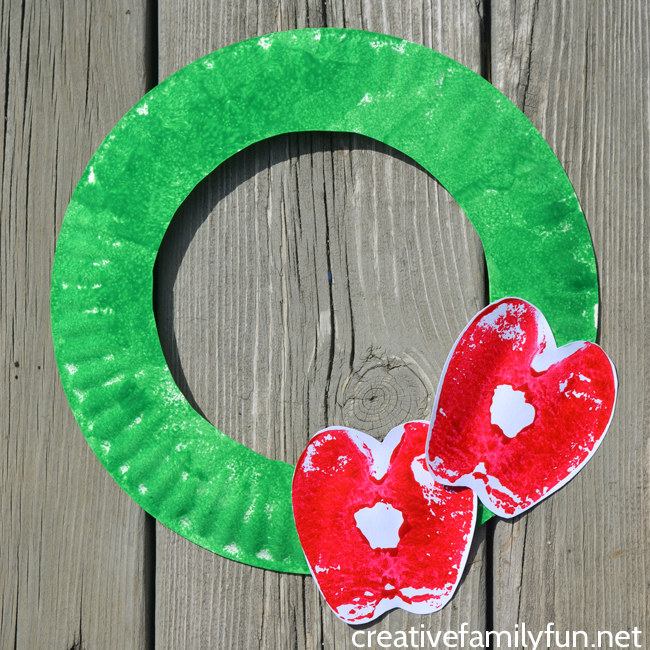 This fun Apple Print Wreath is a fun apple craft for kids to make this fall. It's a great craft for preschool and older kids and a fun fall decoration.