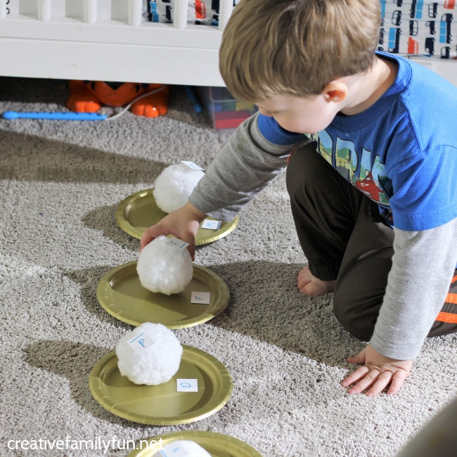 Your toddler or preschooler will have fun moving and learning their abc's with this simple gross motor Snowball Toss Alphabet Game.